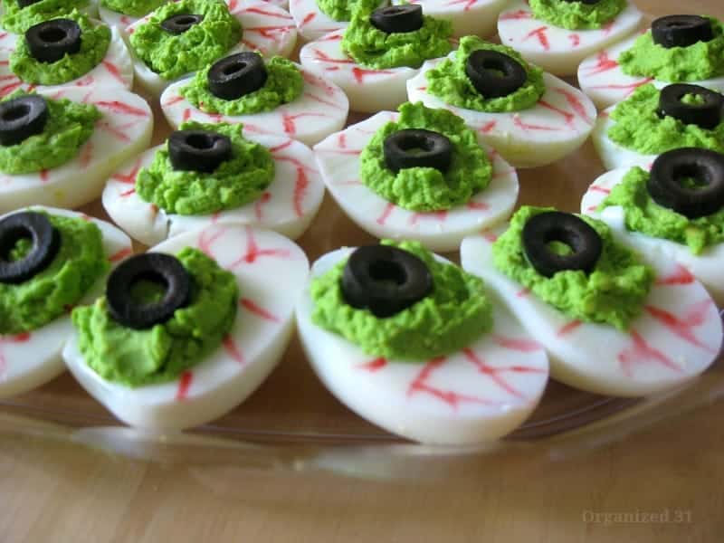 green deviled egg eye ball appetizer.