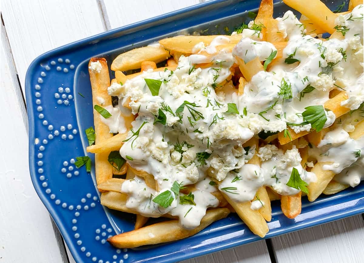 overhead shot of Greek feta cheese fries on a blue plate.