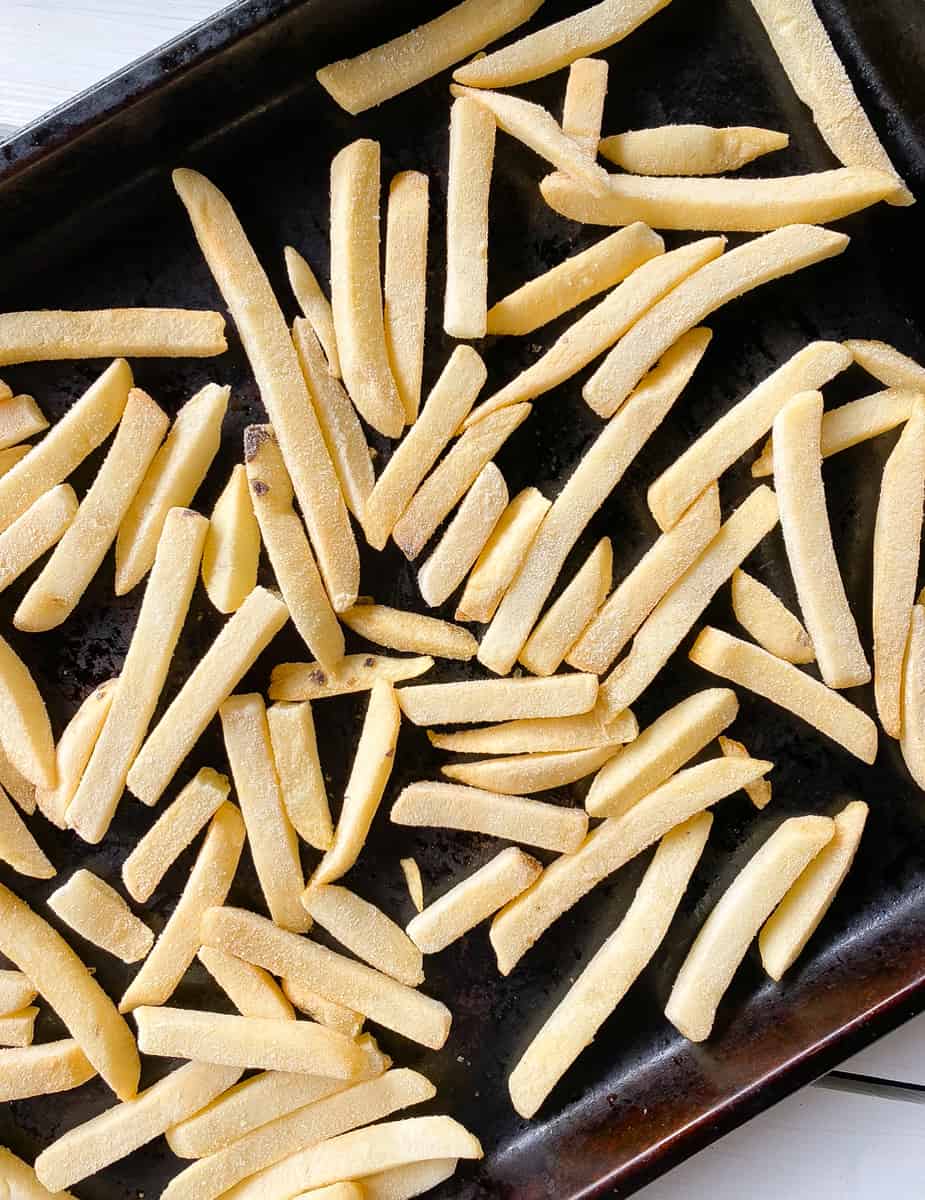 Frozen fries on a baking sheet.