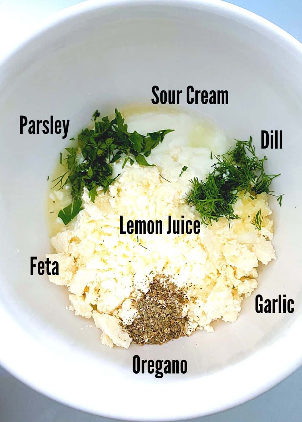 Greek feta fries sauce ingredients in a white bowl.