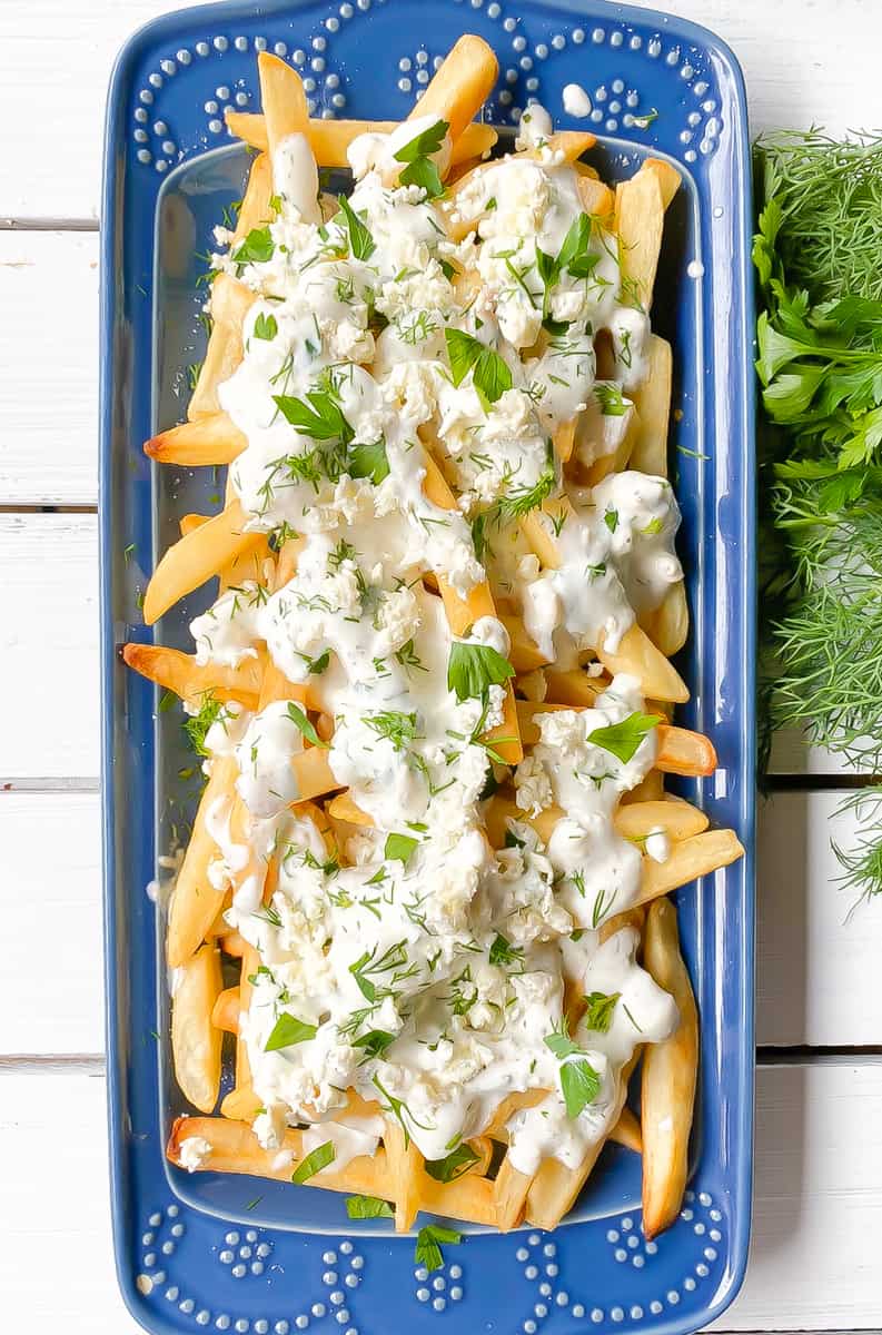 baked french fries smothered in feta cheese and yogurt.