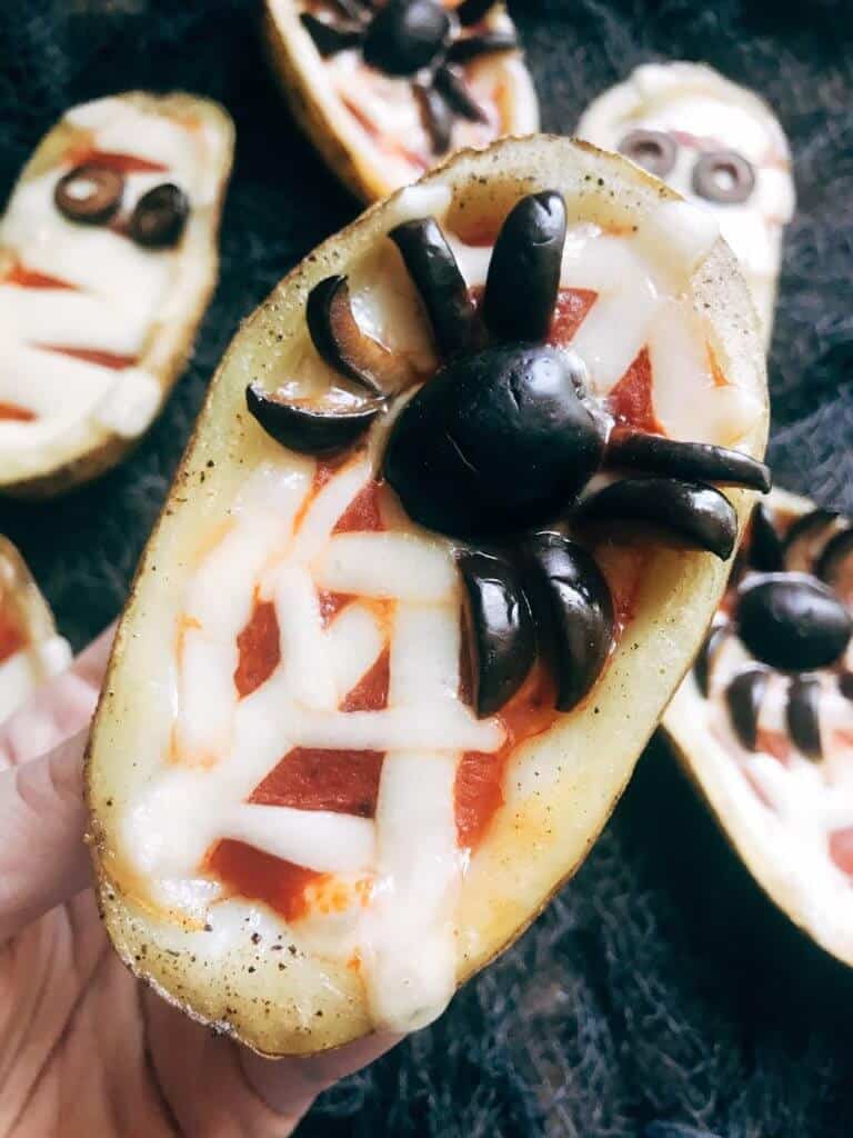 Fun potato skins appetizer with olive spider on top.