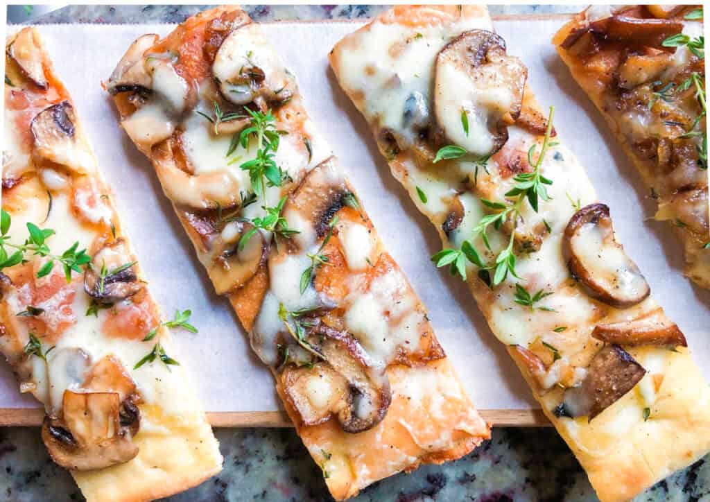 overhead shot of homemade mushroom flatbread on a cutting board