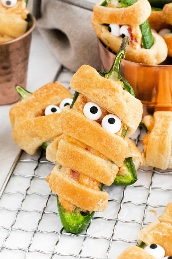 jalapeno poppers appetizer wrapped in dough to look like mummies.