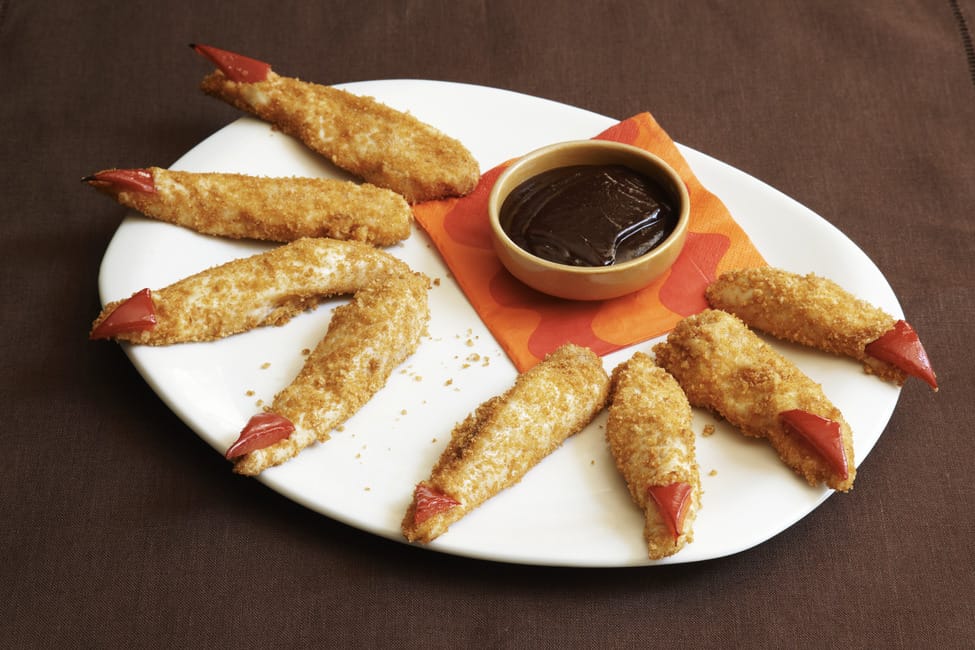 Chicken fingers appetizer that look like monster fingers on a plate.
