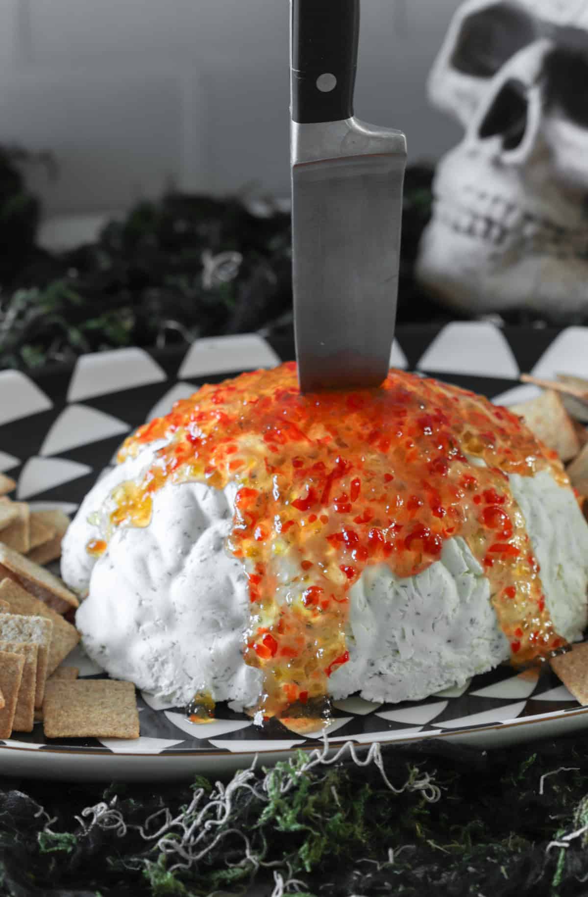 Brian mold dip with red pepper jelly on top.