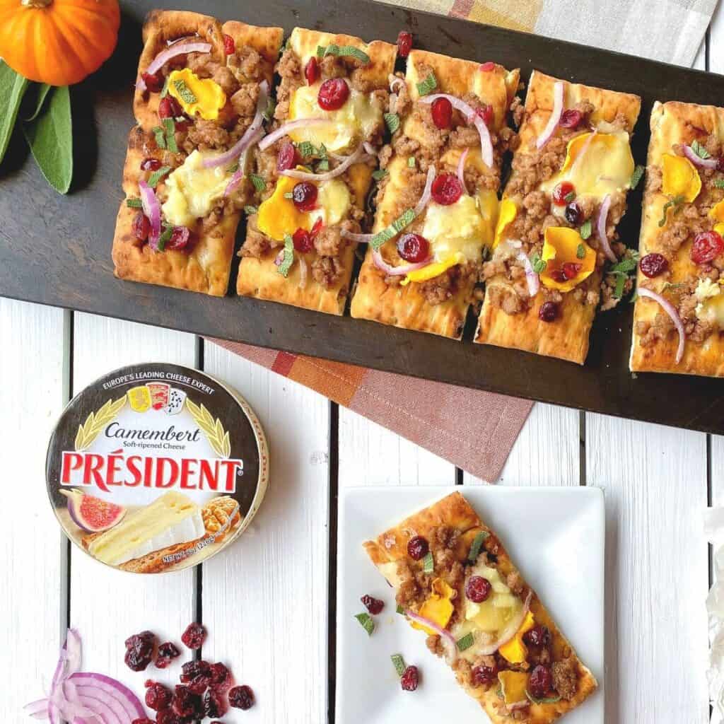 Pumpkin sausage flatbread on table.