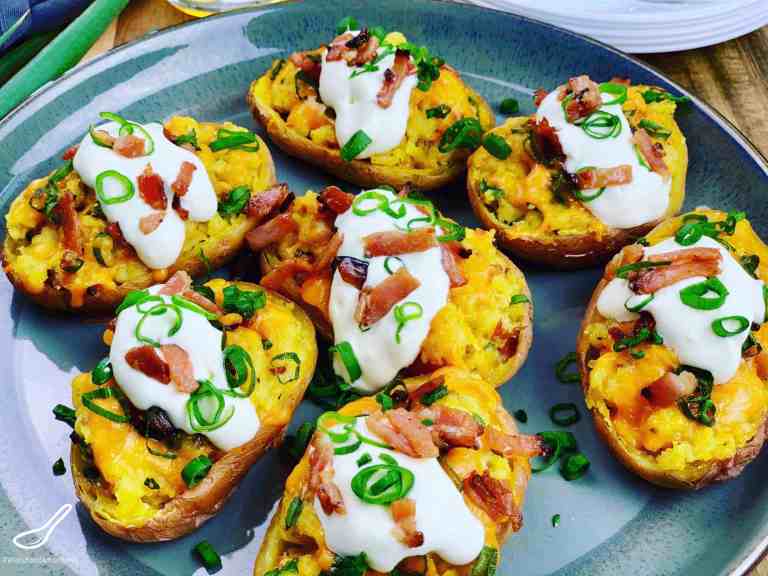 twice baked potatoes topped with sour cream and bacon.