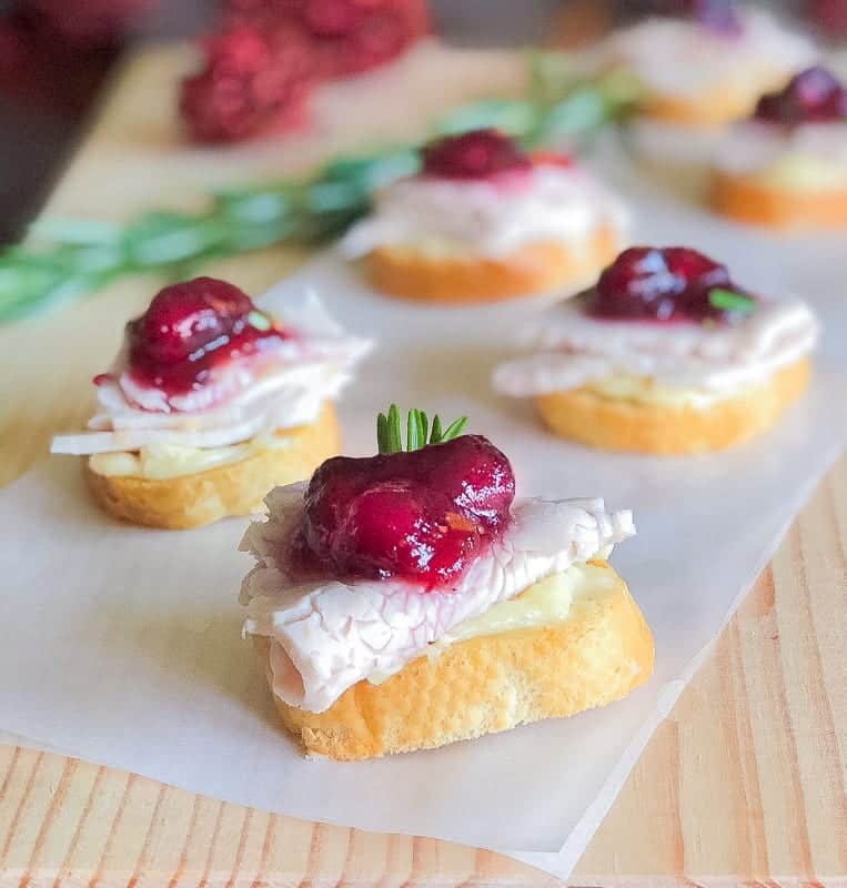 Turkey crostini appetizer with cranberry and brie.