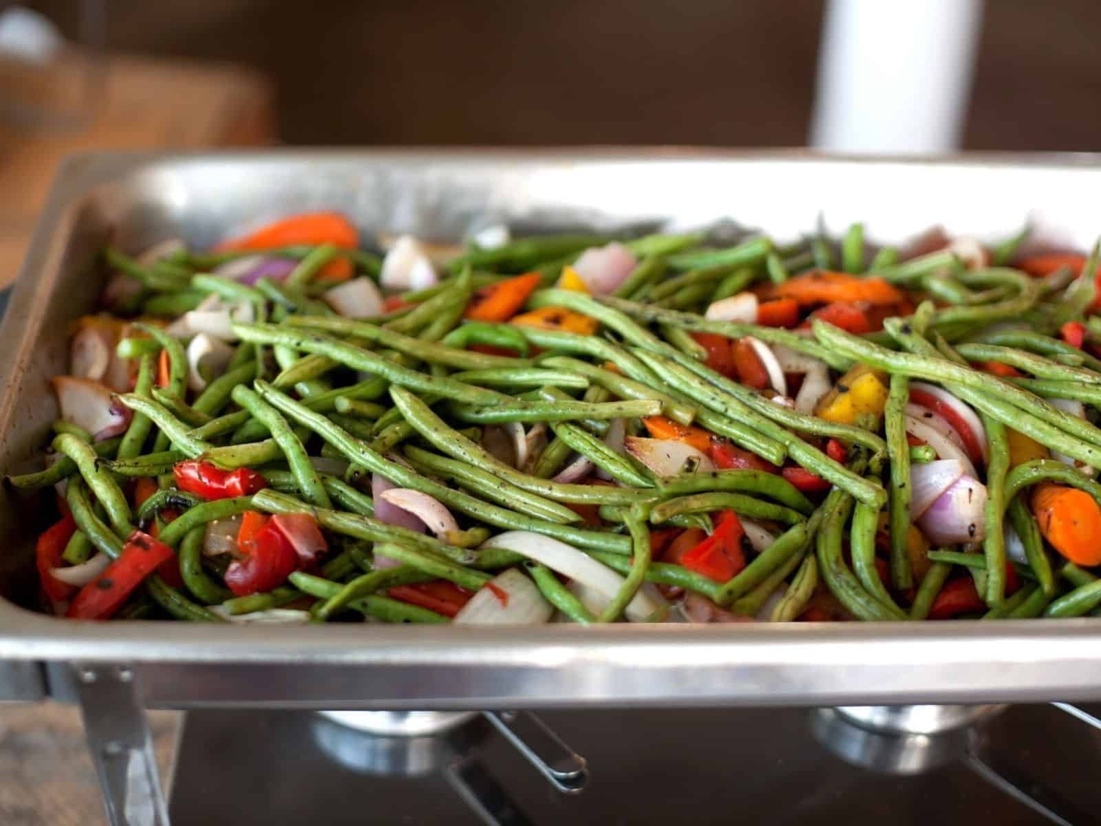 chafing dish with green beans and veggies.