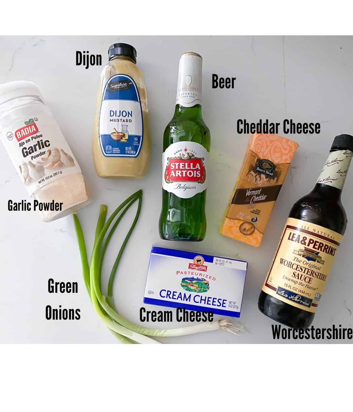 Ingredients laid on table to make cheesy beer dip.