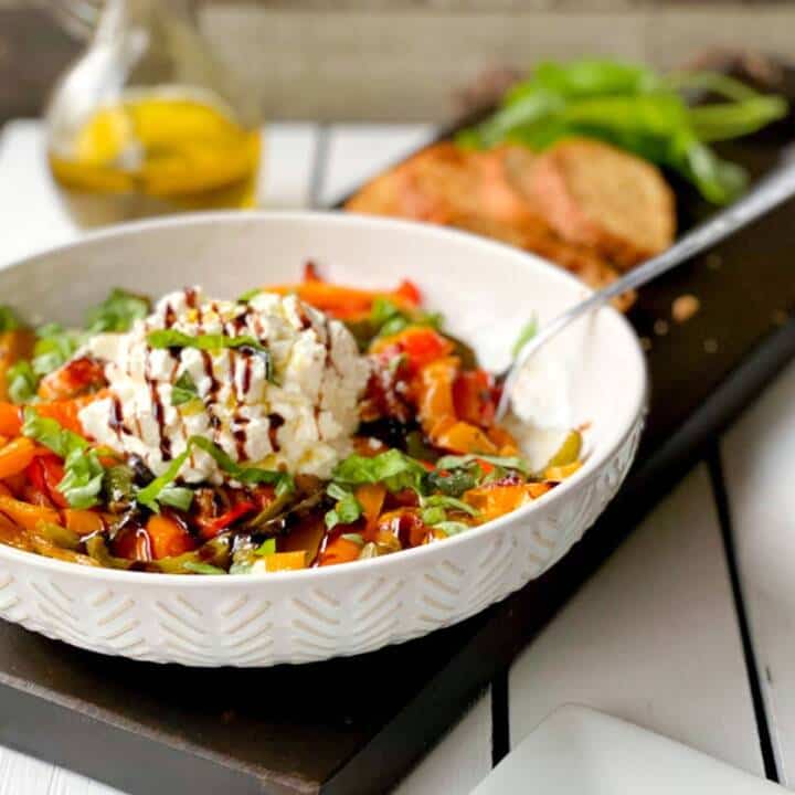 Burrata cheese peppers and garlic in a bowl for serving.