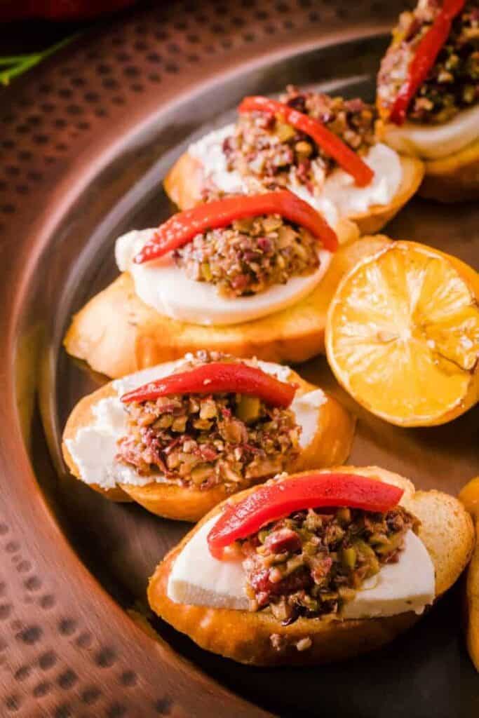 olive tapenade crostini with lemon on the side.