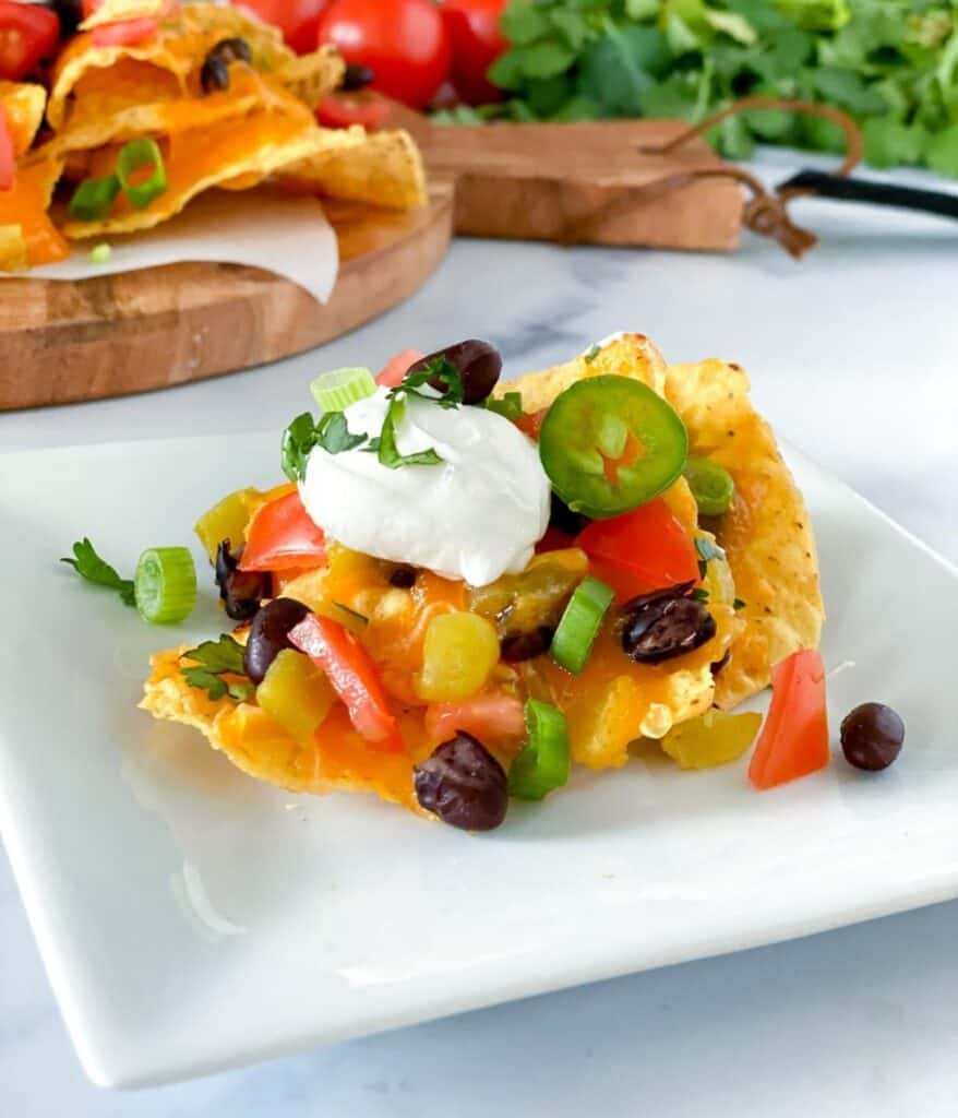 Loaded air fryer nachos on a plate.