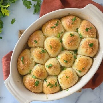 cheesy stuffed biscuits with garlic in a casserole dish.