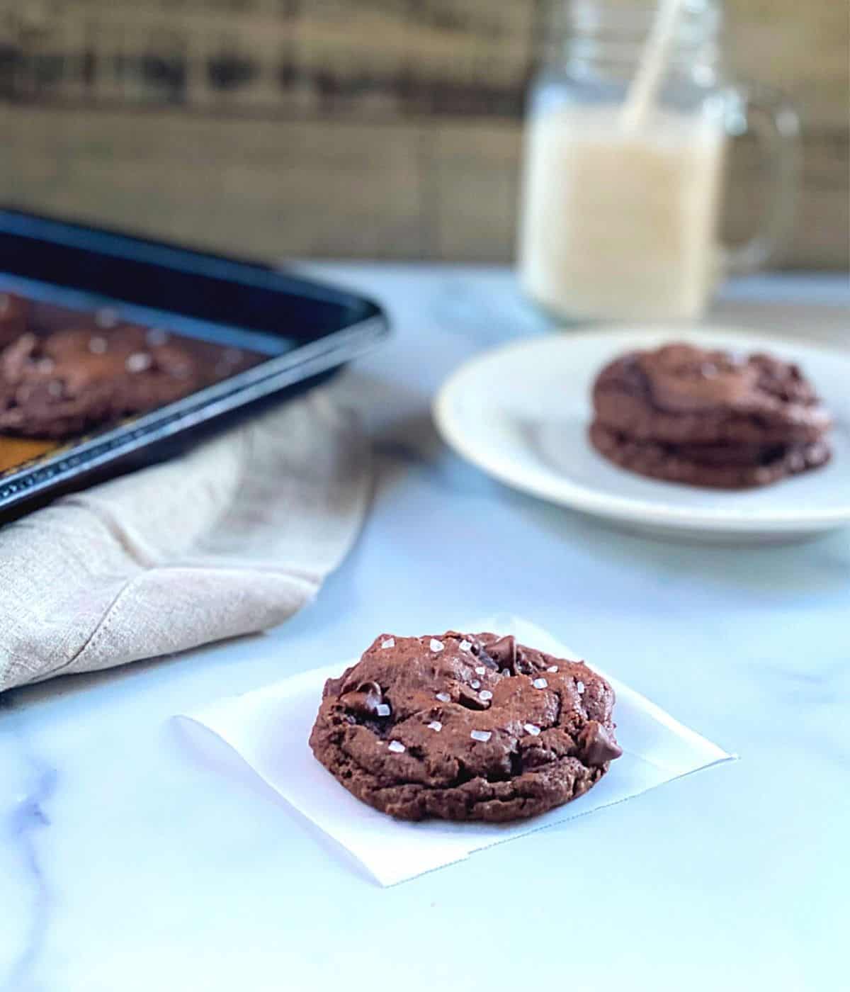 Chocolate chip cake batter cookies on wax paper square with sea salt.