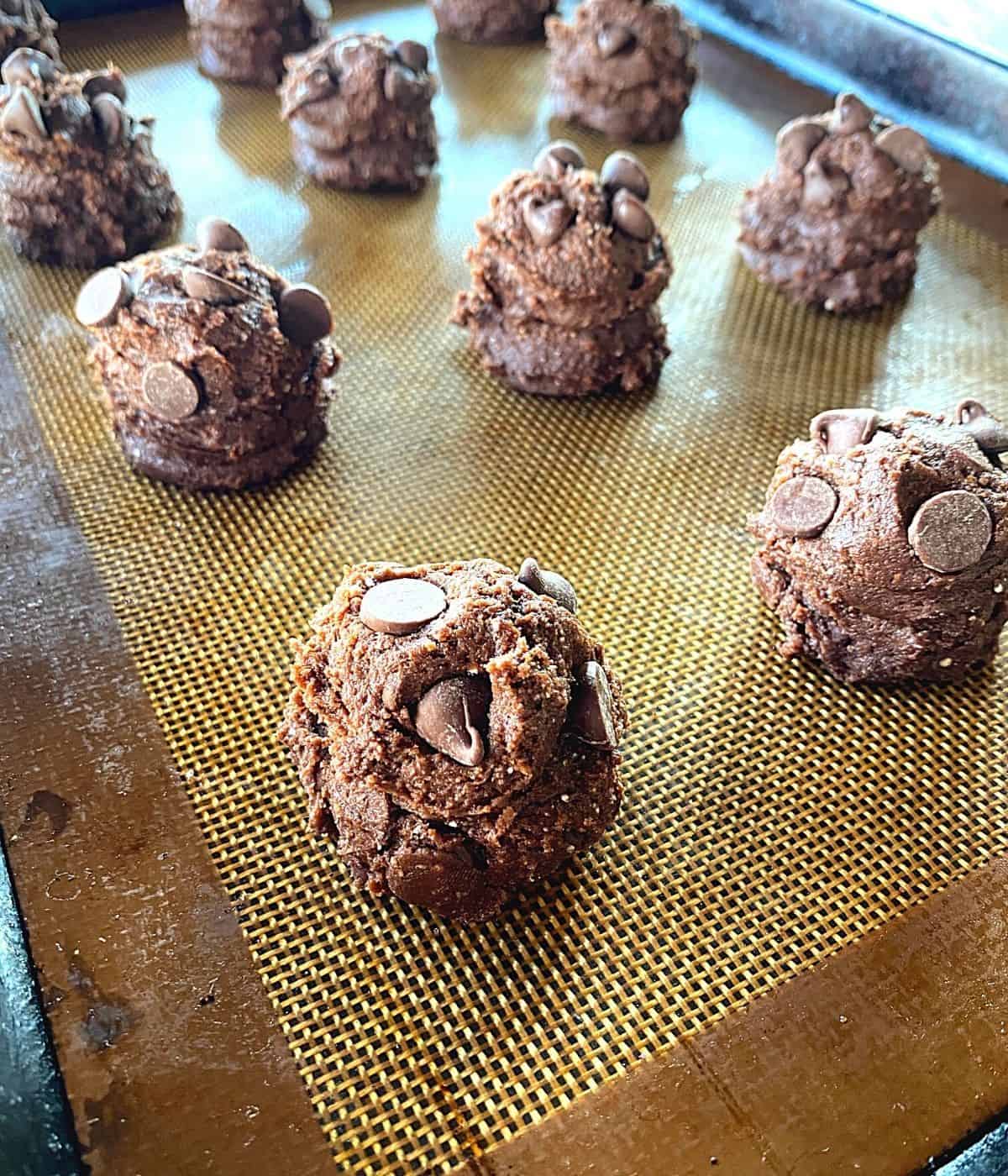 raw chocolate chip cake mix cookie balls on baking sheet.