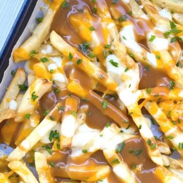 disco fries on a baking sheet with gravy.