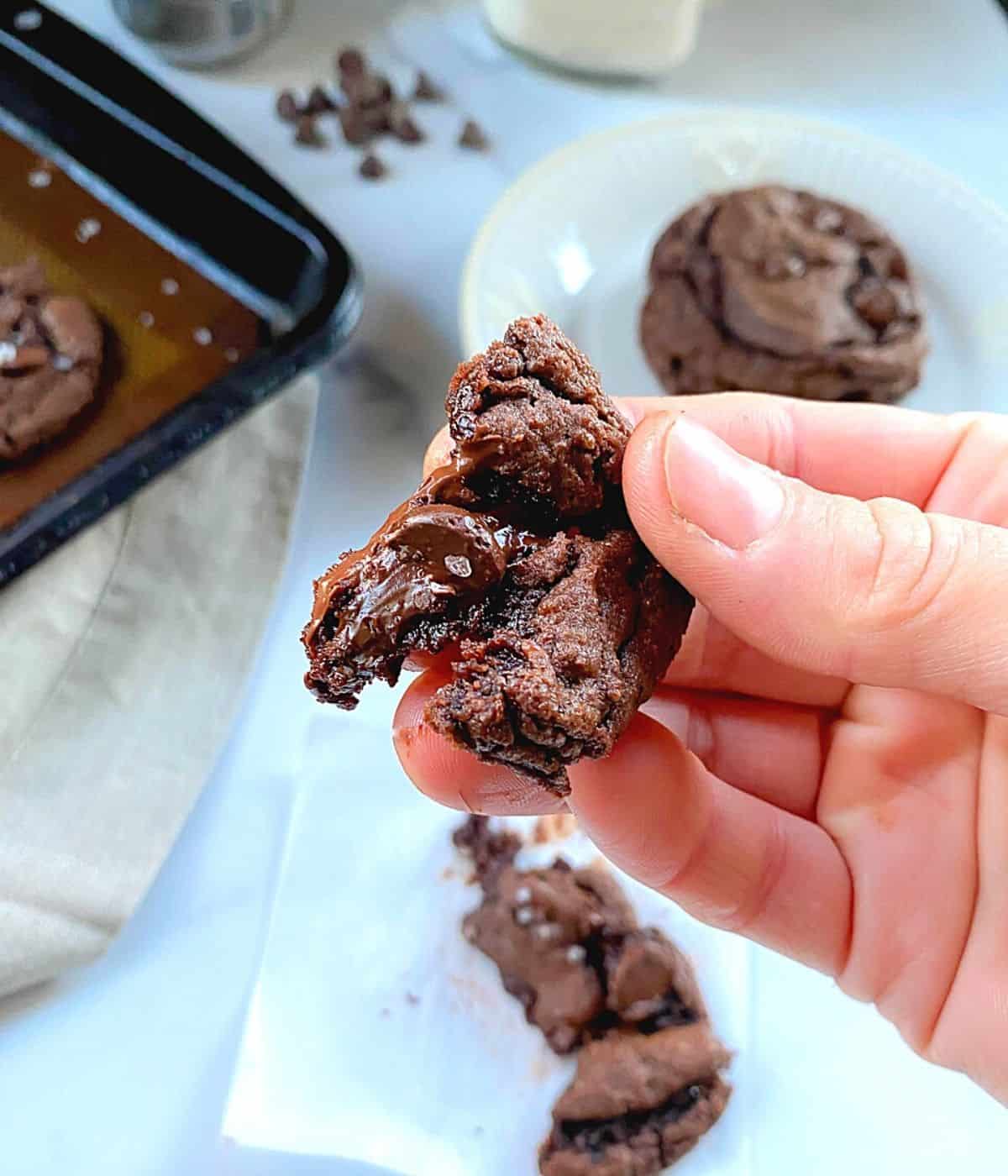 hand holding gooey chocolate chip cake mix cookie.