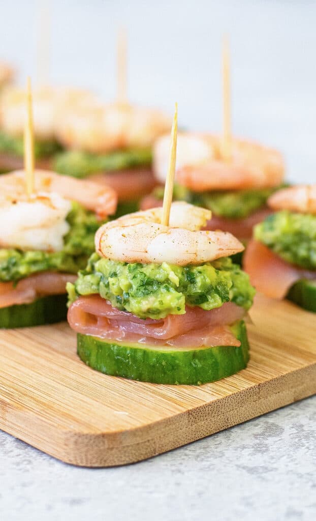 shrimp and green guacamole skewers on cucumbers.