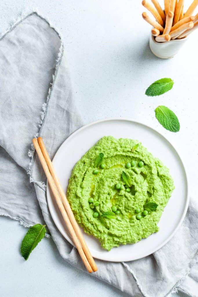pea and mint dip on a white plate.