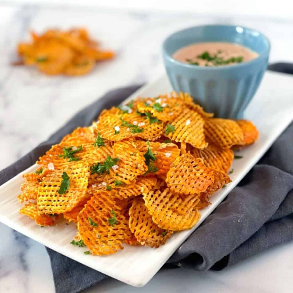 air fryer sweet potato chips on a plate.