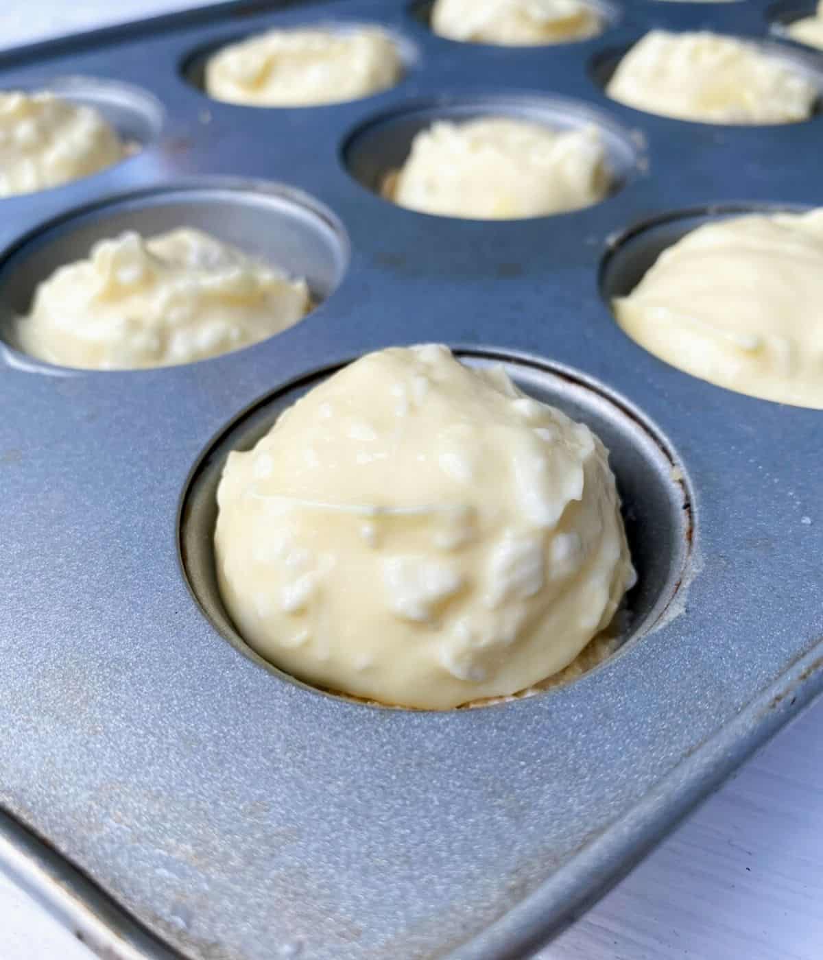 Cheesecake batter in mini muffin tin.