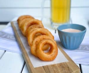 beer battered onion rings on cutting board.