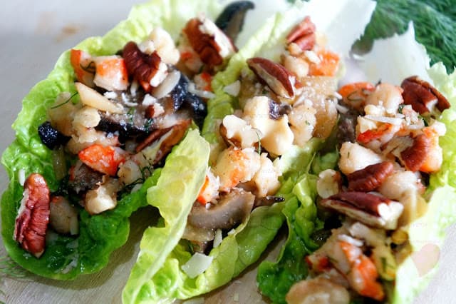 lettuce boats filled with shrimp and nut mixture.