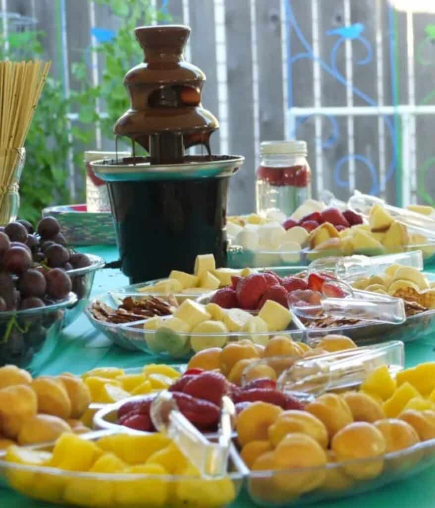 chocolate waterfall on a table with fruit.