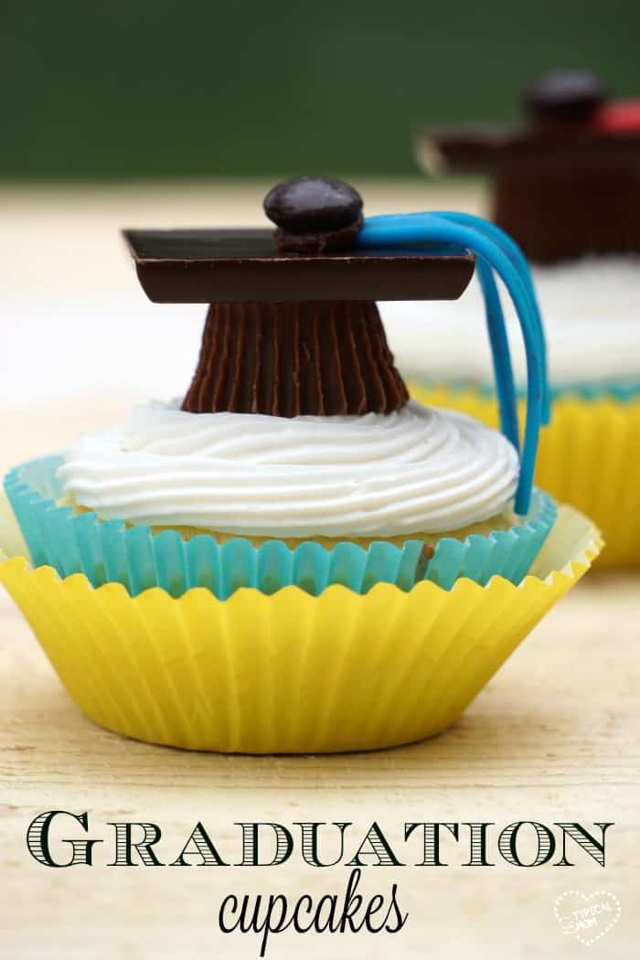 Graduation party cupcakes on table with grad hat on top.