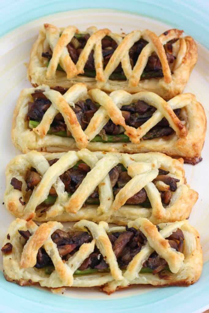 A row of mushroom and asparagus pastires.