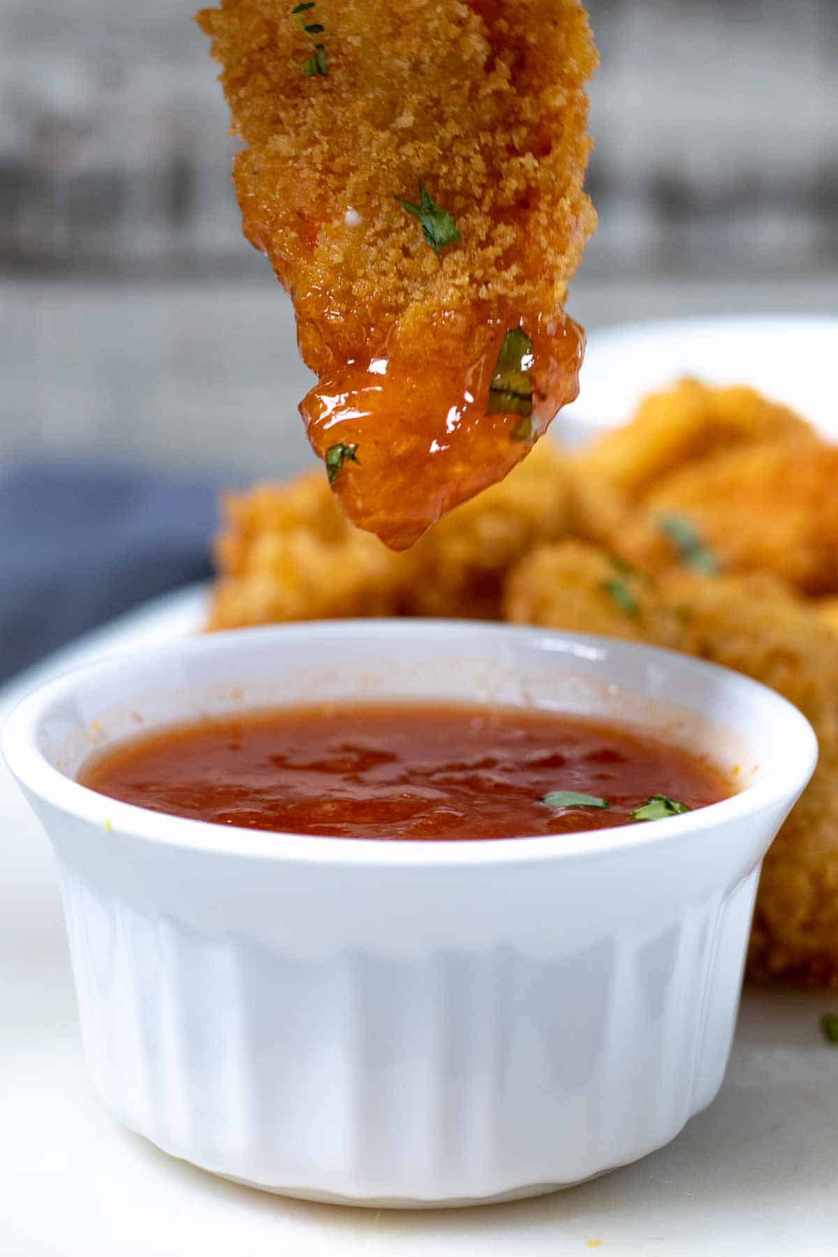 Butterflied shrimp dipped into sweet chili sauce.