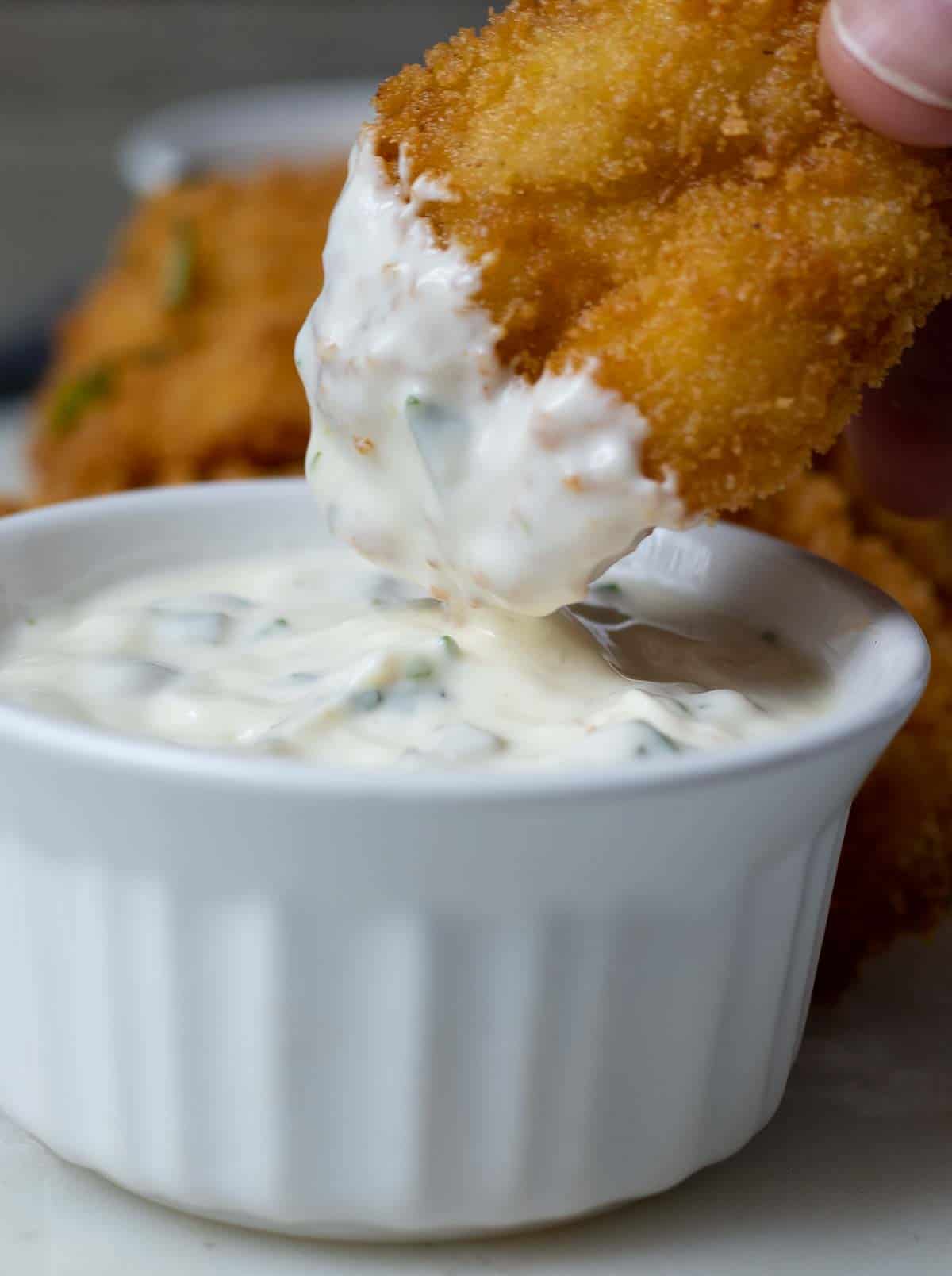 Butterflied fried shrimp dipped into tarter sauce.