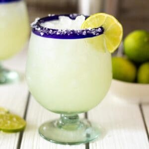 Classic margarita on table without sugar and lime garnish.