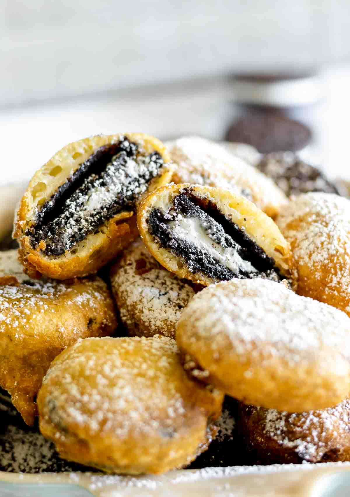 The inside of a deep fried Oreo cookie dusted with powdered sugar.