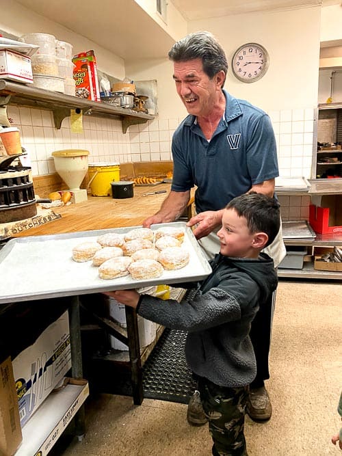 Calvin helping his grandfather with donuts.