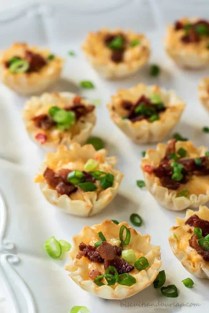 A row of Pimento Cheese Appetizers with a green onion garnish. 