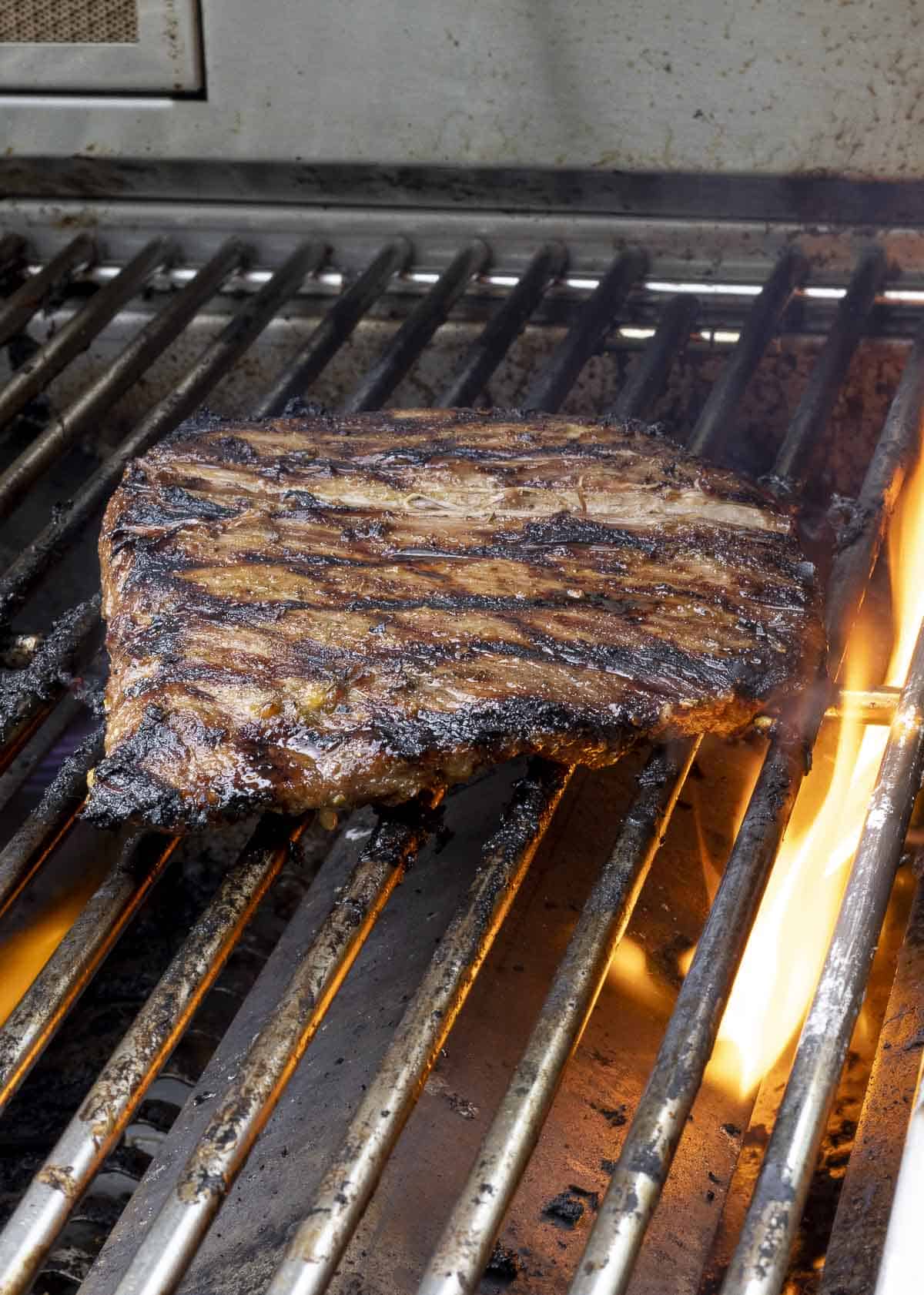 Carne asada grilling on grill.