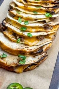 Tortillas with cheese and sliced steak.