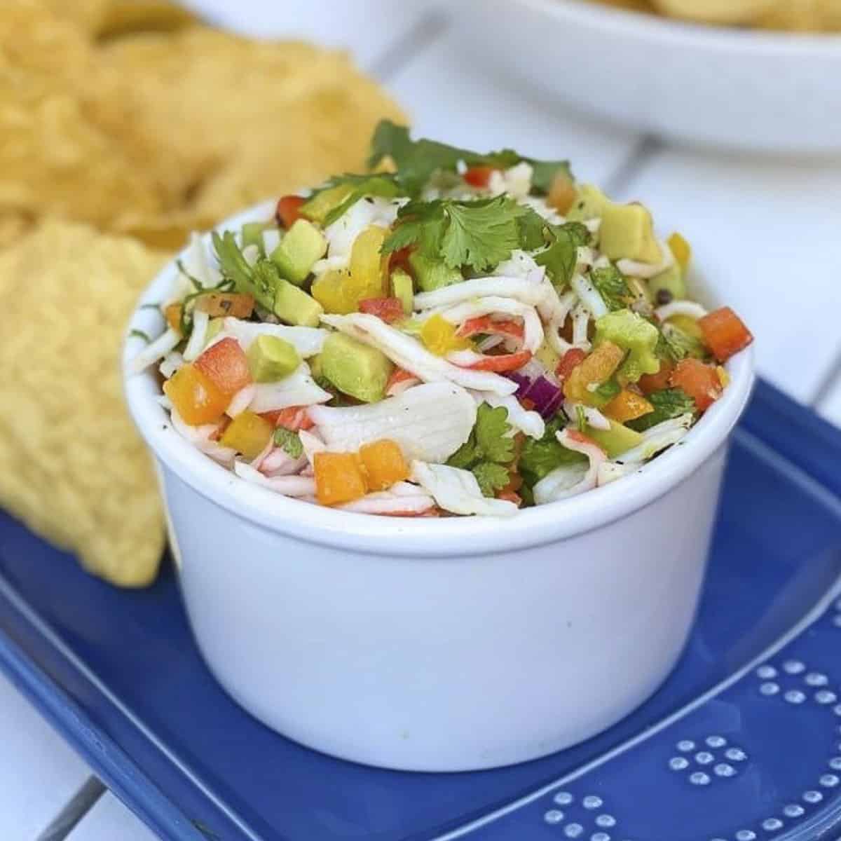 Crab ceviche in a bowl with tortilla chips.