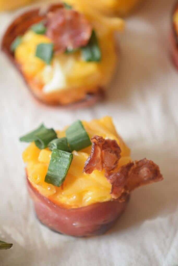 C lose up of a bacon-wrapped mac and cheese bite appetizer. 
