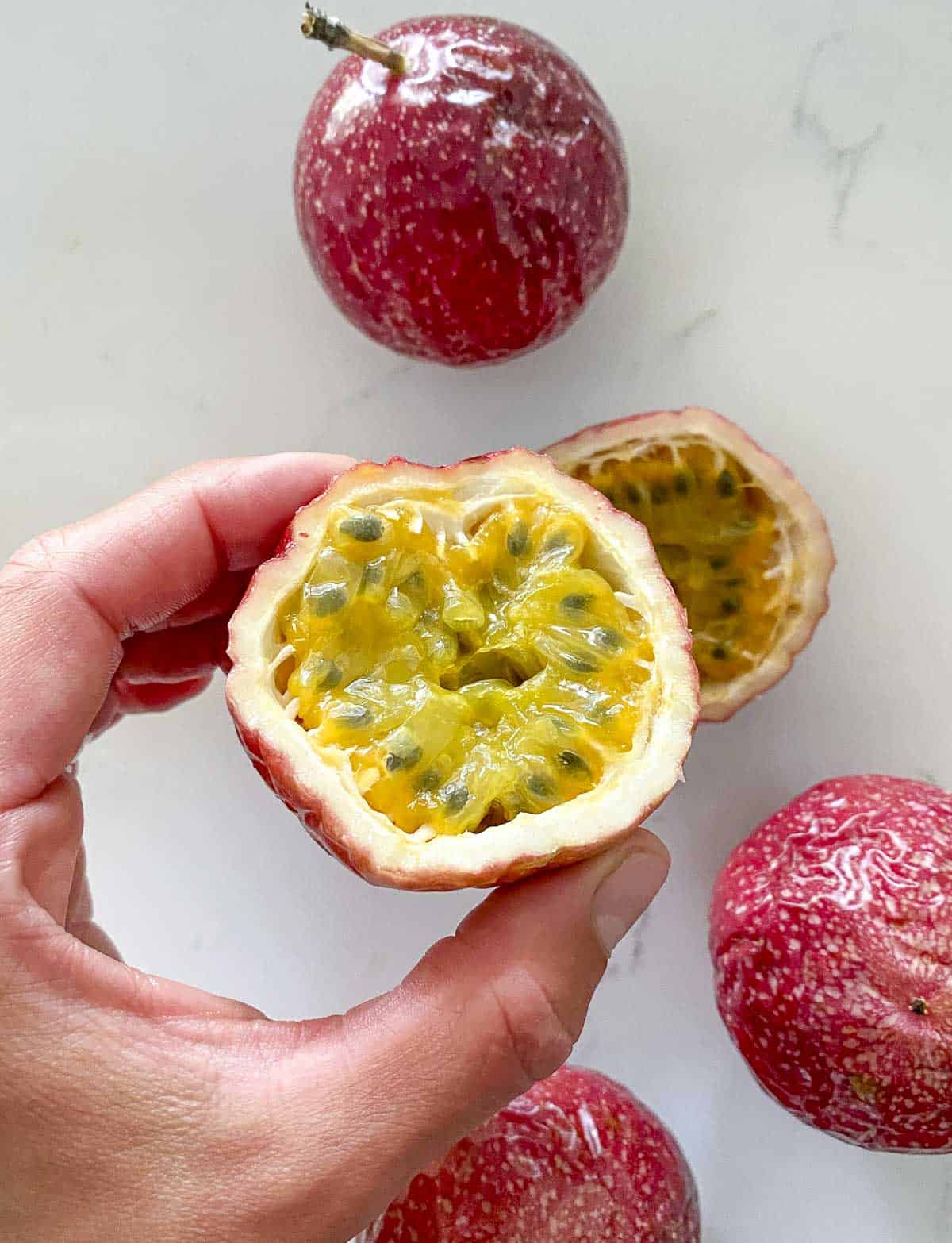 Fresh passion fruit cut in half.