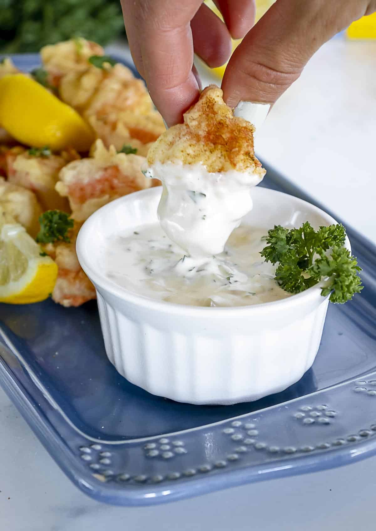 Imitation crab stick fried and dipped into tarter sauce.