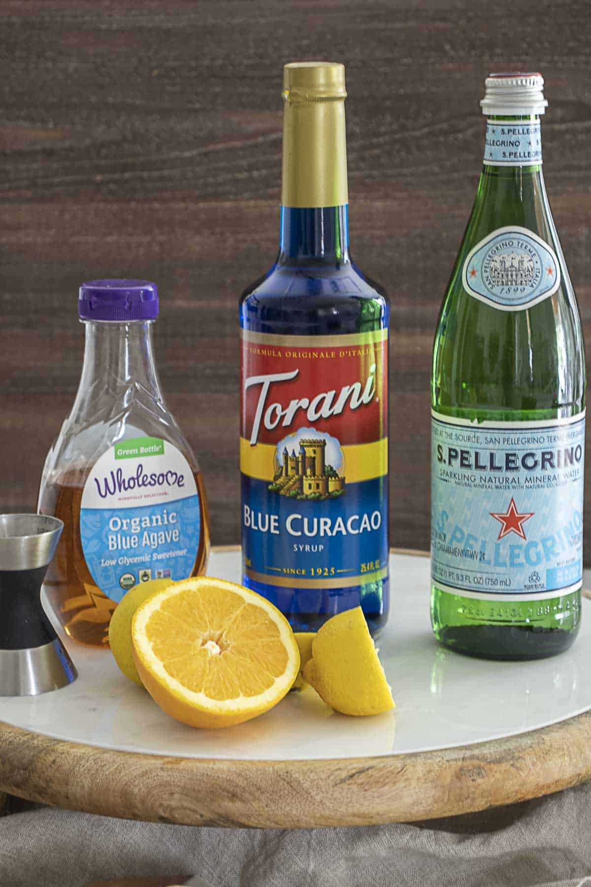Ingredients to make a blue lagoon mocktail on table.