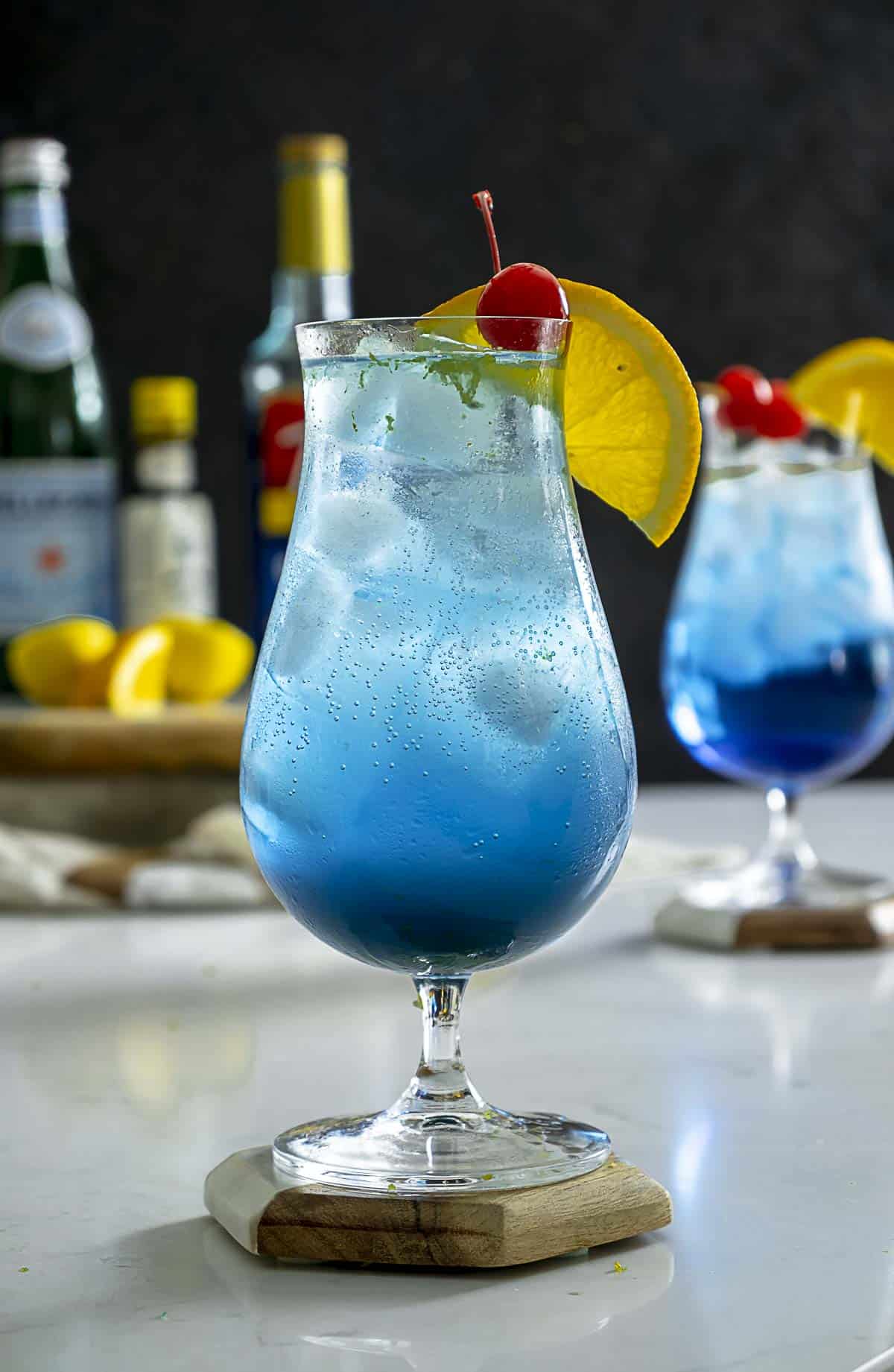Blue lagoon drink without alcohol on table.