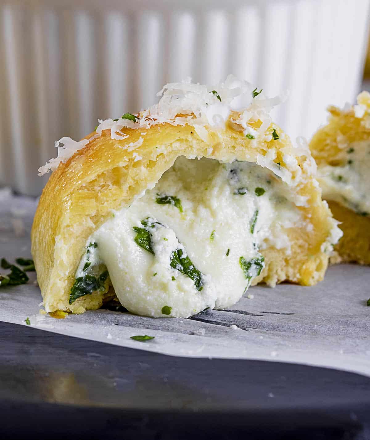 Close up of cut open calzone mini with ricotta and mozzarella cheese oozing out.