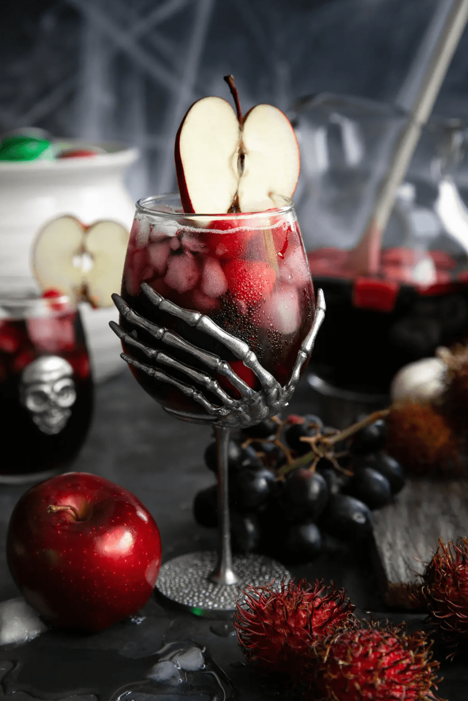 Black magic halloween sangria with apple and fruit. 