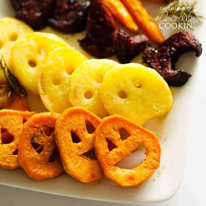 Roasted vegetables cut into spooky faces.