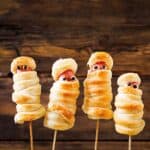 Halloween party mummy dogs appetizer on a stick.
